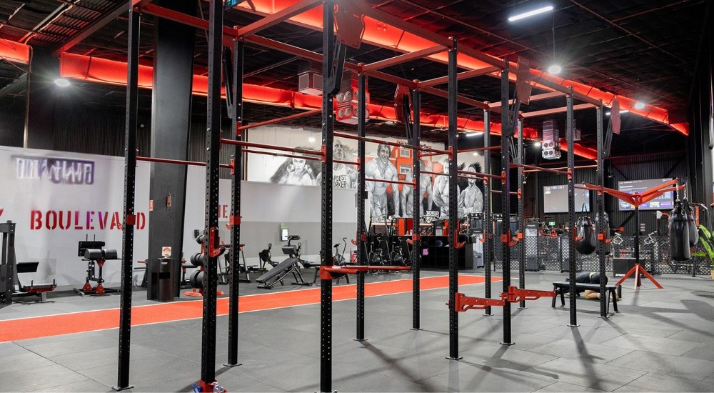 Commercial gym with functional training rig and turf track